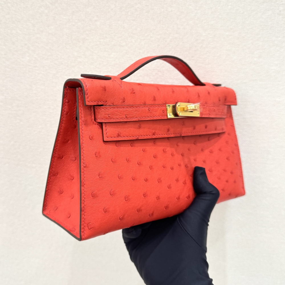 The Hermès Mini Kelly I (also known as the Kelly Pochette) Ostrich Leather Handbag is one of the brand's classic exotic leather models.
