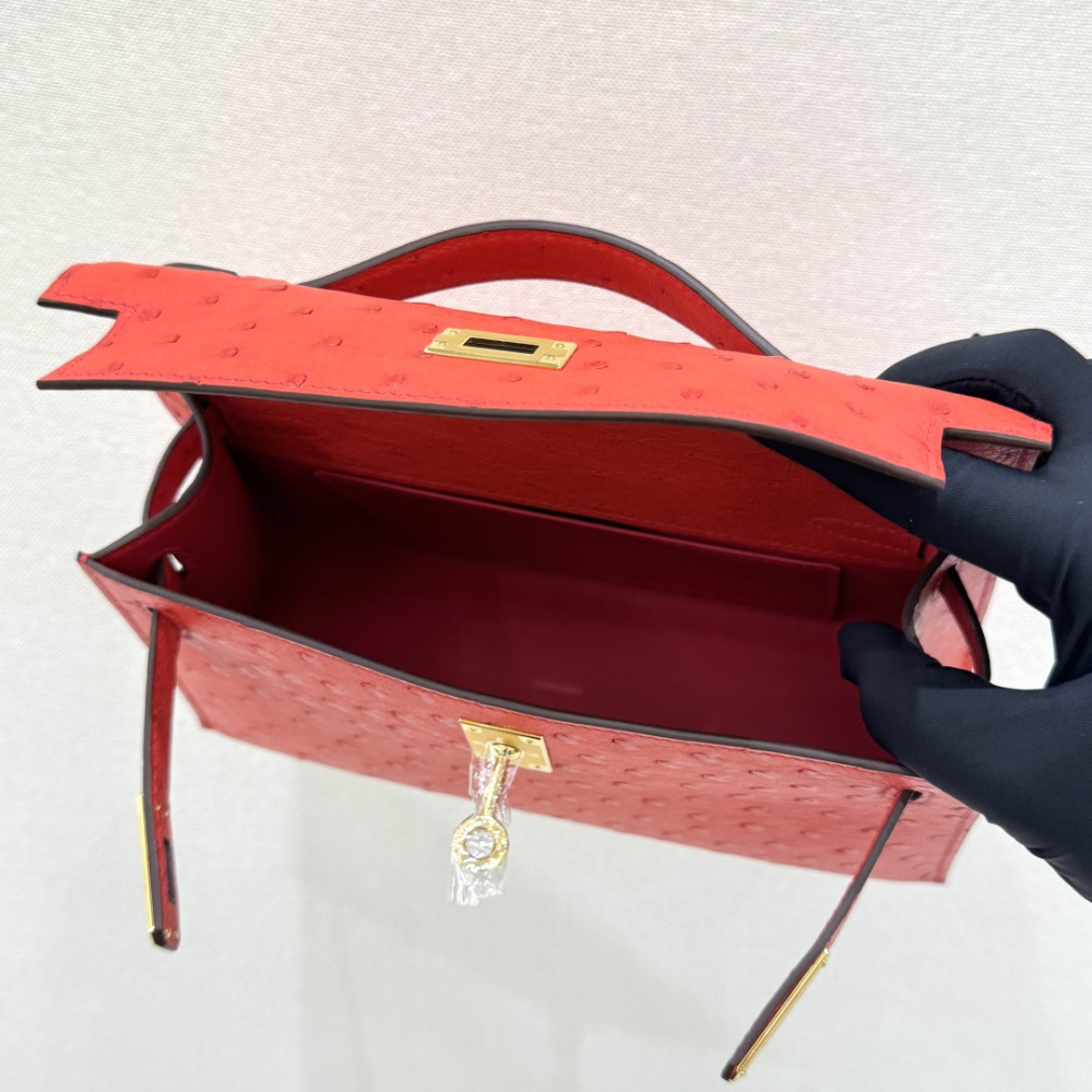 The Hermès Mini Kelly I (also known as the Kelly Pochette) Ostrich Leather Handbag is one of the brand's classic exotic leather models.