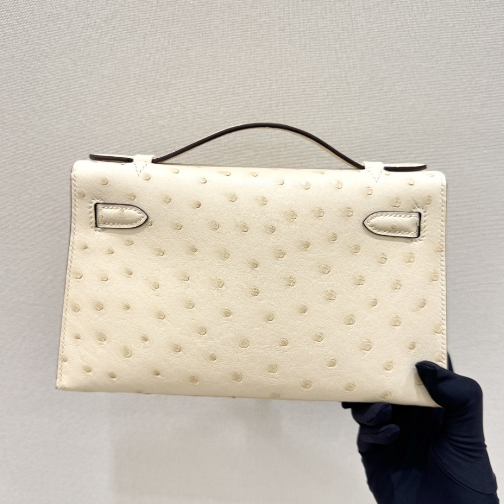 The Hermès Mini Kelly I (also known as the Kelly Pochette) Ostrich Leather Handbag is one of the brand's classic exotic leather models.