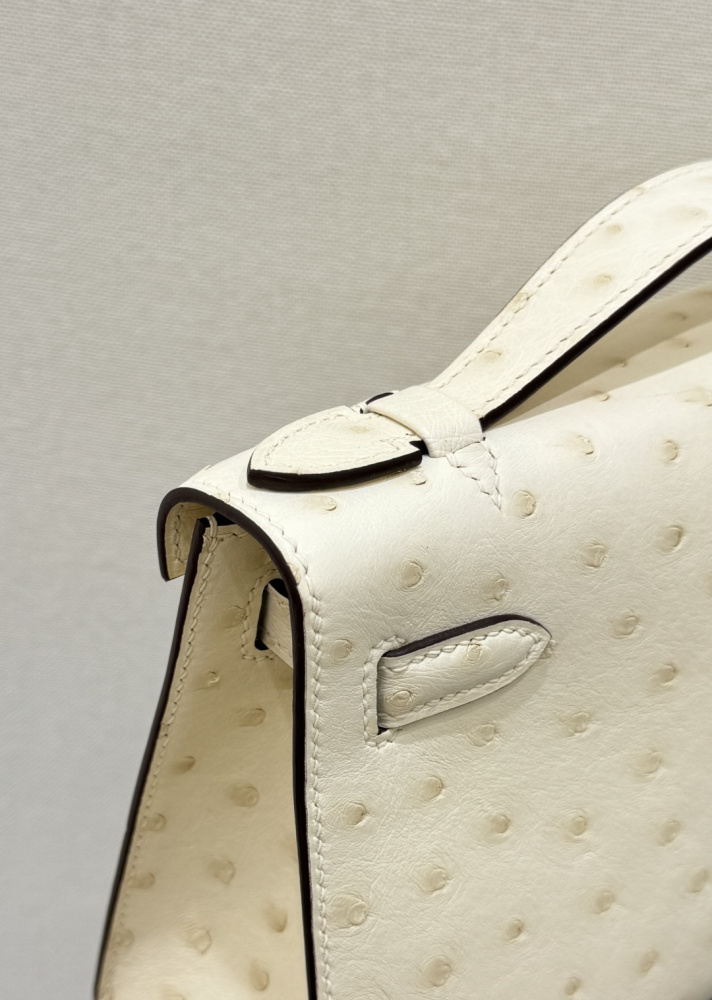 The Hermès Mini Kelly I (also known as the Kelly Pochette) Ostrich Leather Handbag is one of the brand's classic exotic leather models.