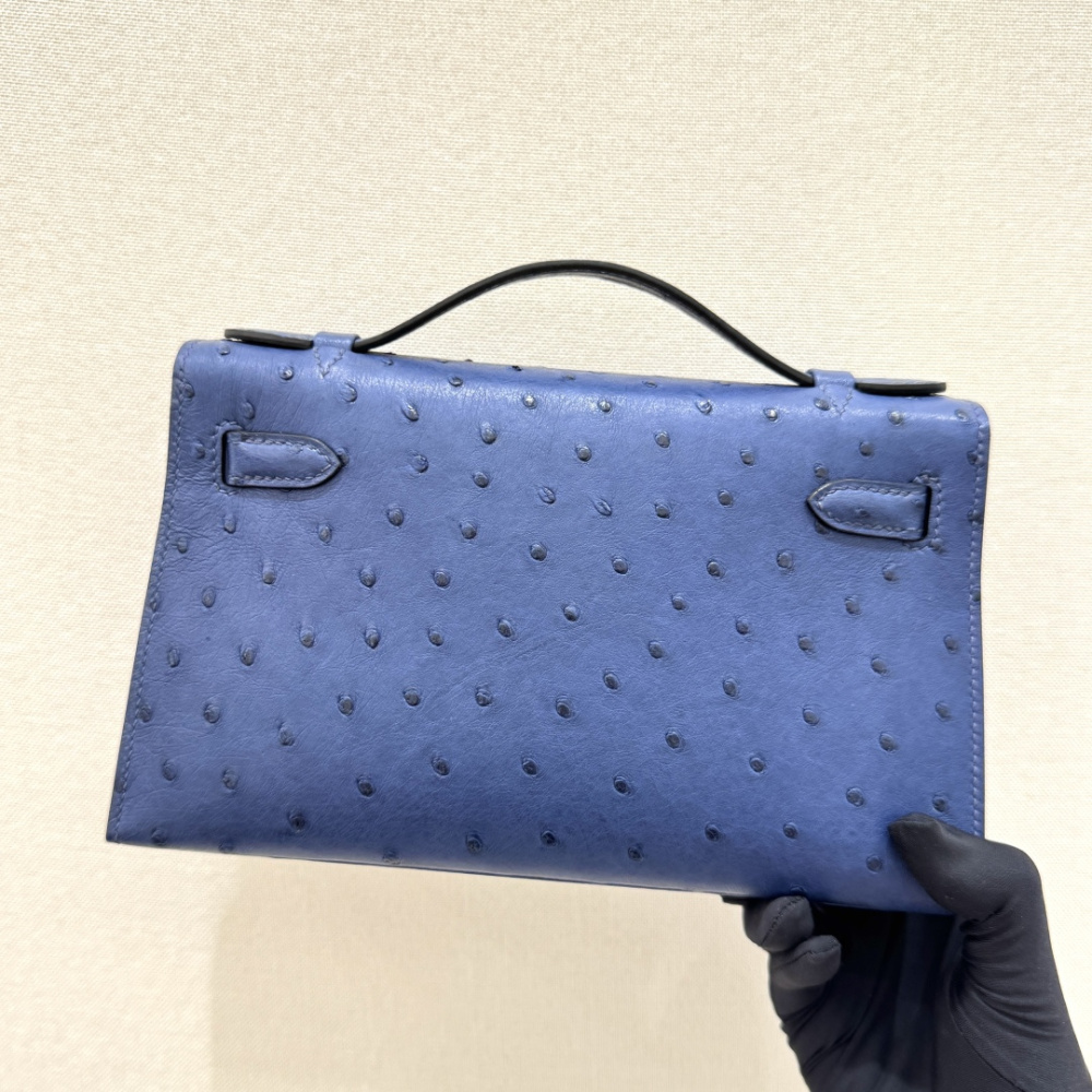The Hermès Mini Kelly I (also known as the Kelly Pochette) Ostrich Leather Handbag is one of the brand's classic exotic leather models.