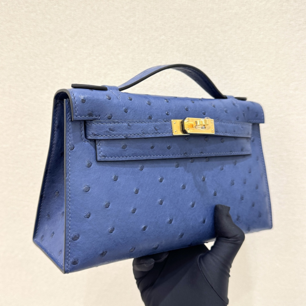 The Hermès Mini Kelly I (also known as the Kelly Pochette) Ostrich Leather Handbag is one of the brand's classic exotic leather models.