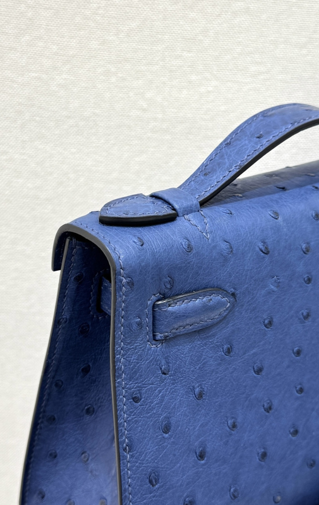 The Hermès Mini Kelly I (also known as the Kelly Pochette) Ostrich Leather Handbag is one of the brand's classic exotic leather models.