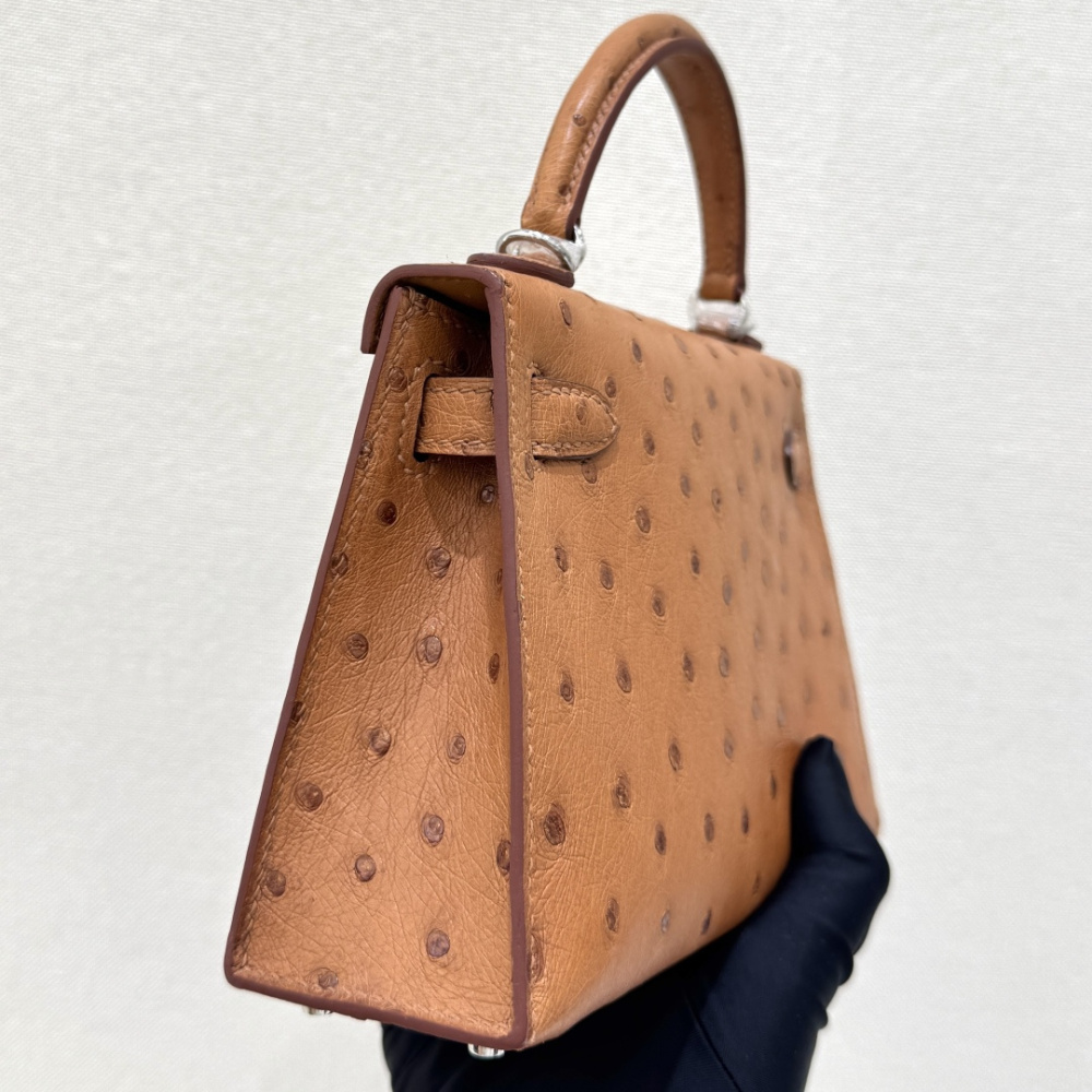 The Hermès Mini Kelly I (also known as the Kelly Pochette) Ostrich Leather Handbag is one of the brand's classic exotic leather models.