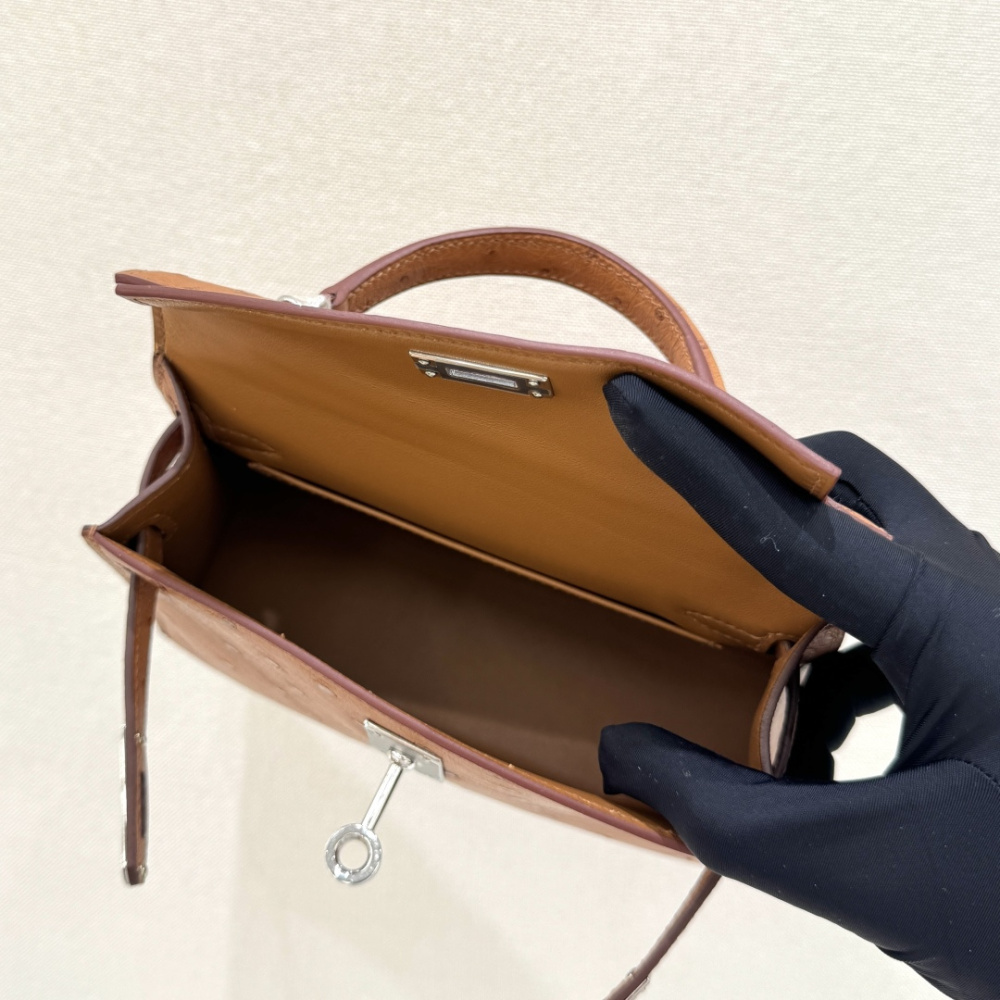 The Hermès Mini Kelly I (also known as the Kelly Pochette) Ostrich Leather Handbag is one of the brand's classic exotic leather models.