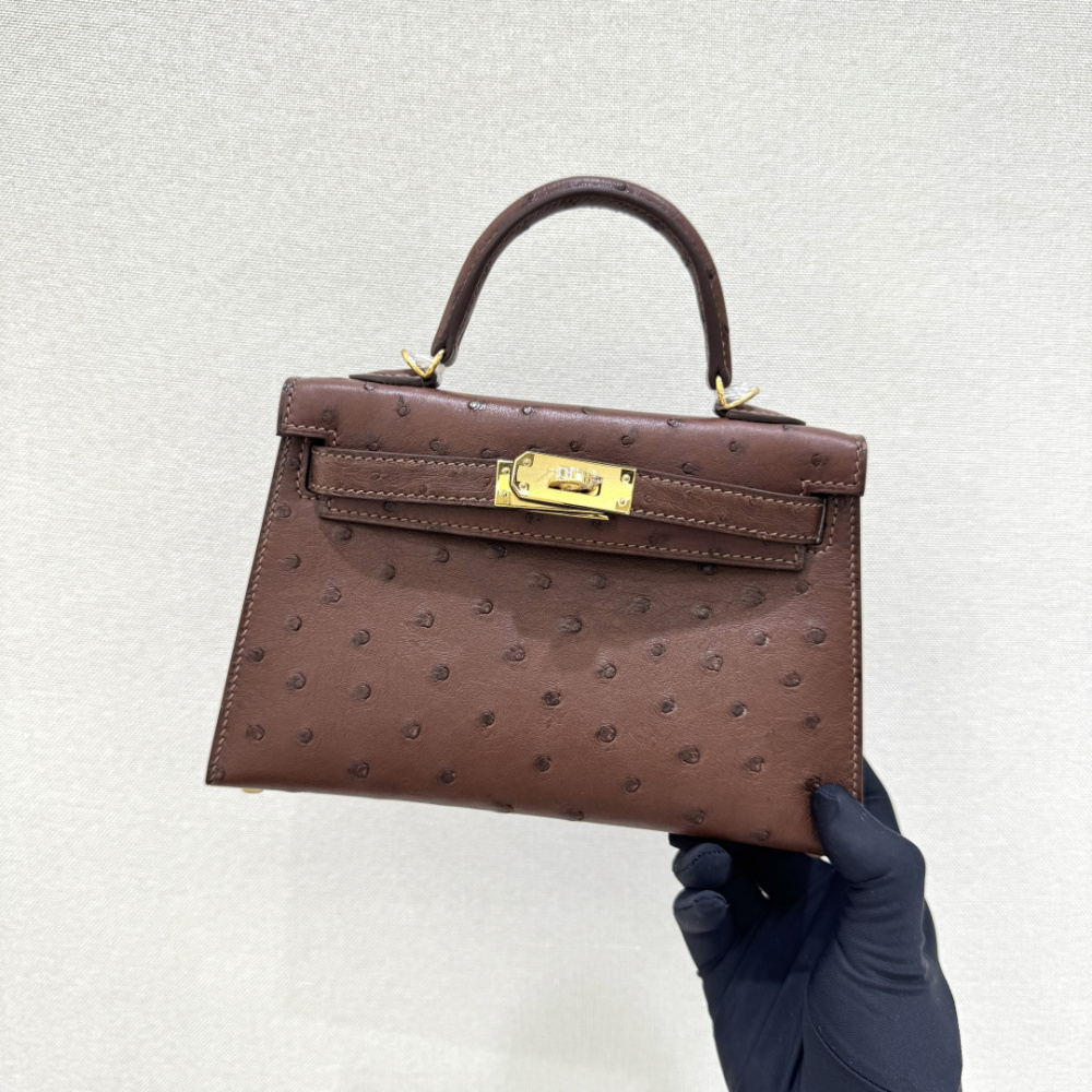 The Hermès Mini Kelly I (also known as the Kelly Pochette) Ostrich Leather Handbag is one of the brand's classic exotic leather models.