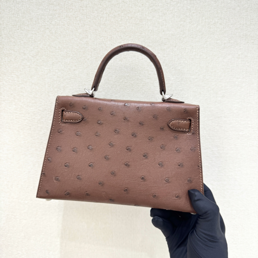 The Hermès Mini Kelly I (also known as the Kelly Pochette) Ostrich Leather Handbag is one of the brand's classic exotic leather models.