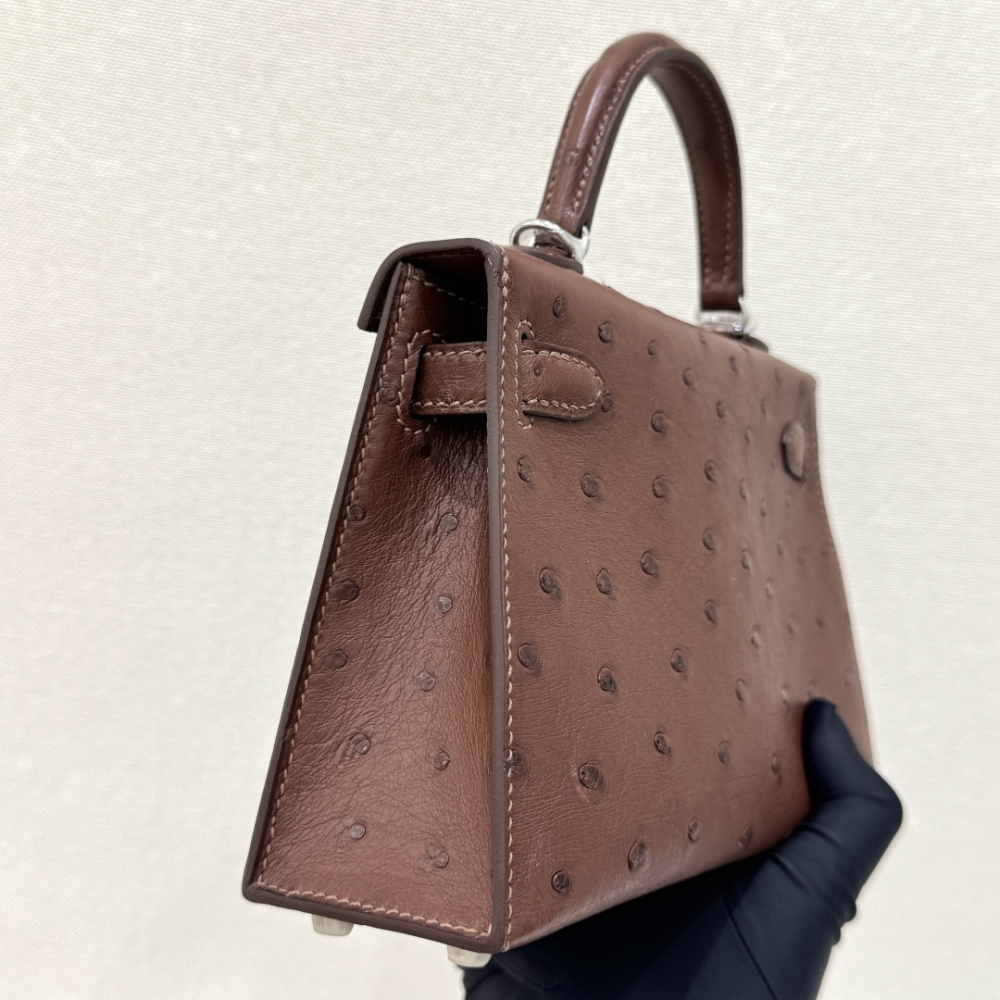 The Hermès Mini Kelly I (also known as the Kelly Pochette) Ostrich Leather Handbag is one of the brand's classic exotic leather models.