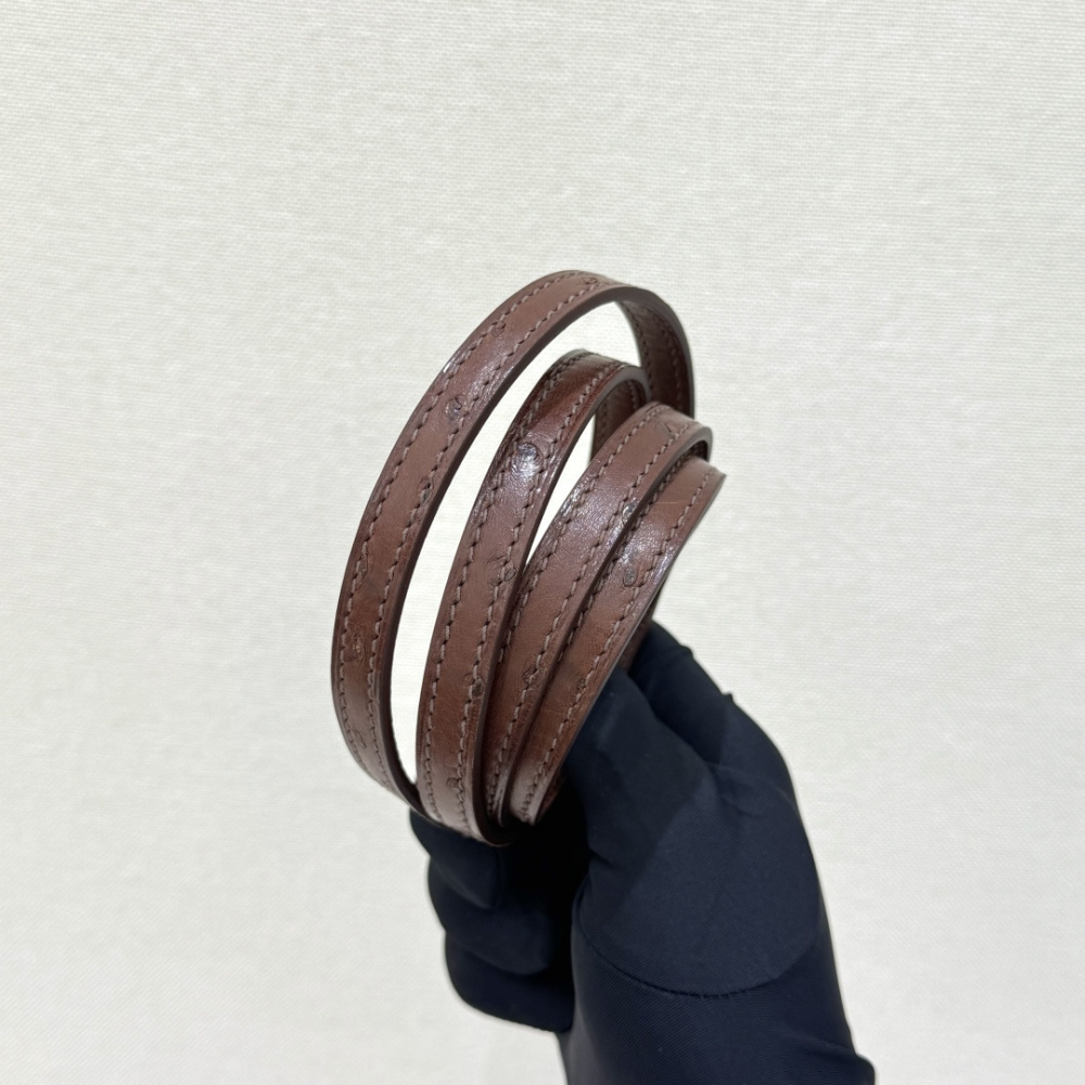 The Hermès Mini Kelly I (also known as the Kelly Pochette) Ostrich Leather Handbag is one of the brand's classic exotic leather models.