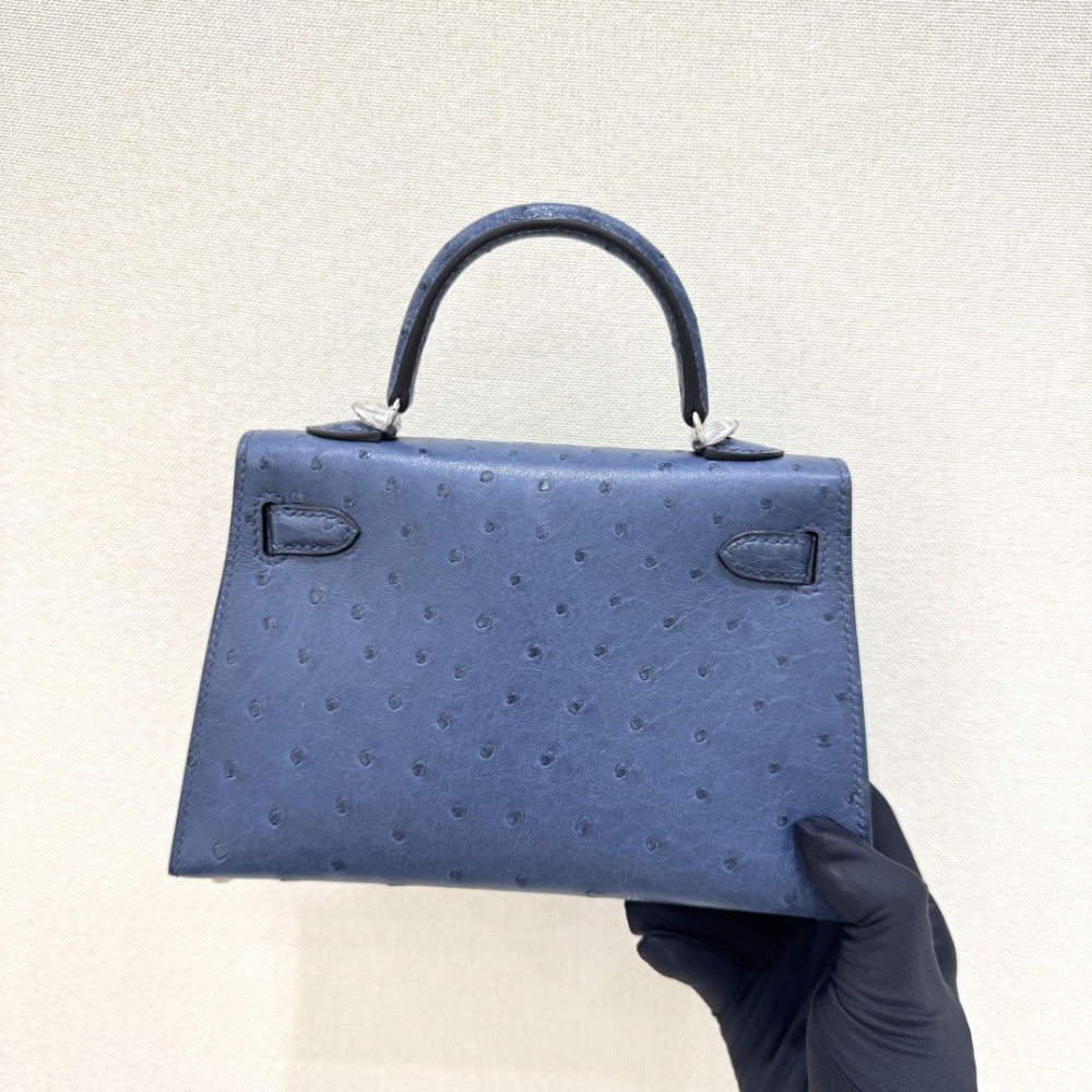 The Hermès Mini Kelly I (also known as the Kelly Pochette) Ostrich Leather Handbag is one of the brand's classic exotic leather models.
