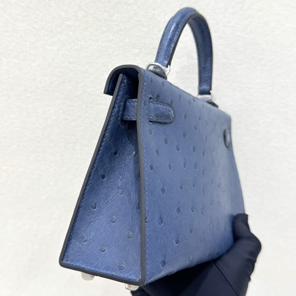 The Hermès Mini Kelly I (also known as the Kelly Pochette) Ostrich Leather Handbag is one of the brand's classic exotic leather models.