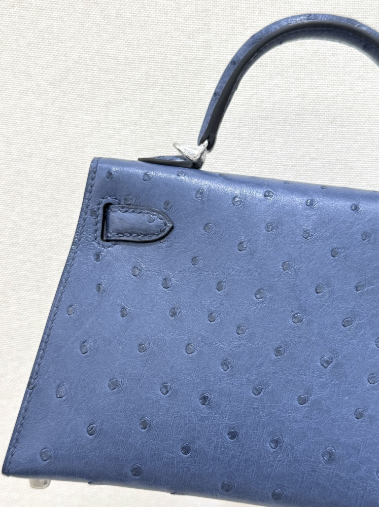The Hermès Mini Kelly I (also known as the Kelly Pochette) Ostrich Leather Handbag is one of the brand's classic exotic leather models.