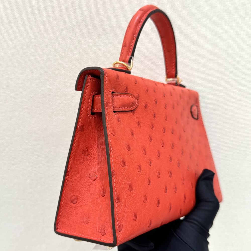 The Hermès Mini Kelly I (also known as the Kelly Pochette) Ostrich Leather Handbag is one of the brand's classic exotic leather models.