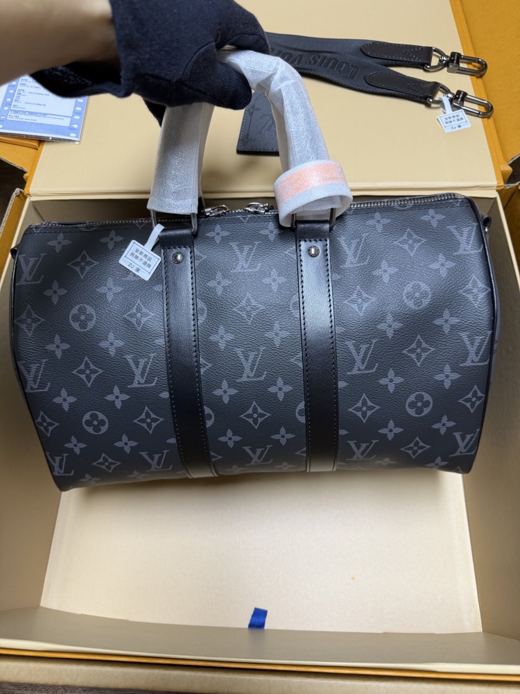 The Louis Vuitton Keepall Bandoulière 35 bag features the classic Monogram Eclipse black and grey canvas.