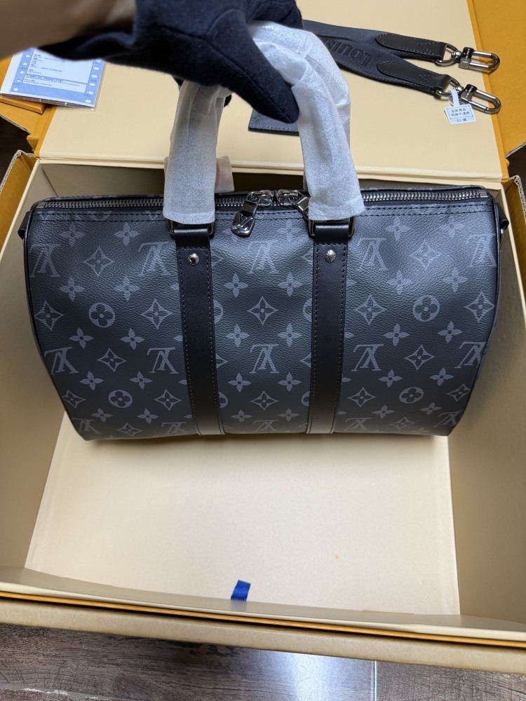 The Louis Vuitton Keepall Bandoulière 35 bag features the classic Monogram Eclipse black and grey canvas.