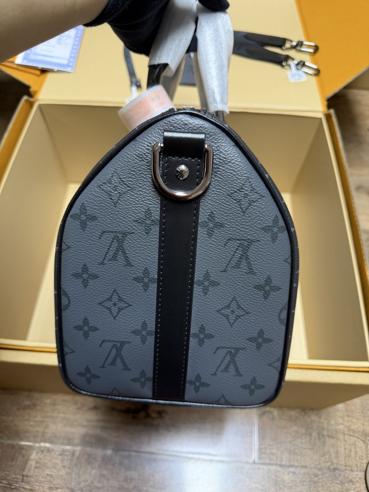 The Louis Vuitton Keepall Bandoulière 35 bag features the classic Monogram Eclipse black and grey canvas.
