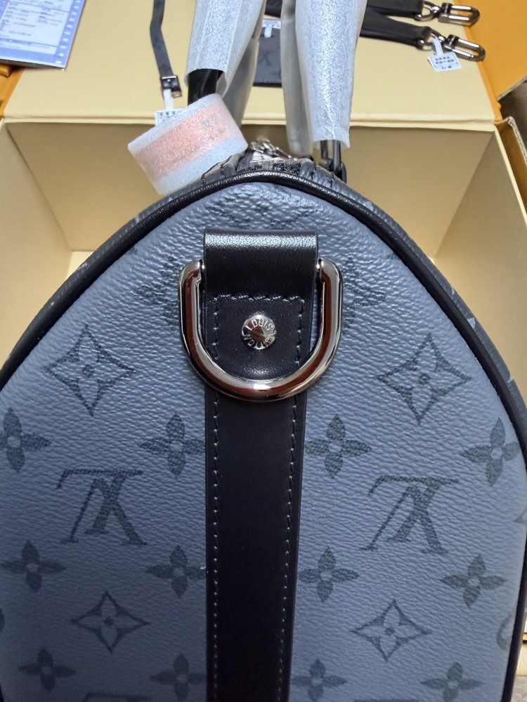 The Louis Vuitton Keepall Bandoulière 35 bag features the classic Monogram Eclipse black and grey canvas.