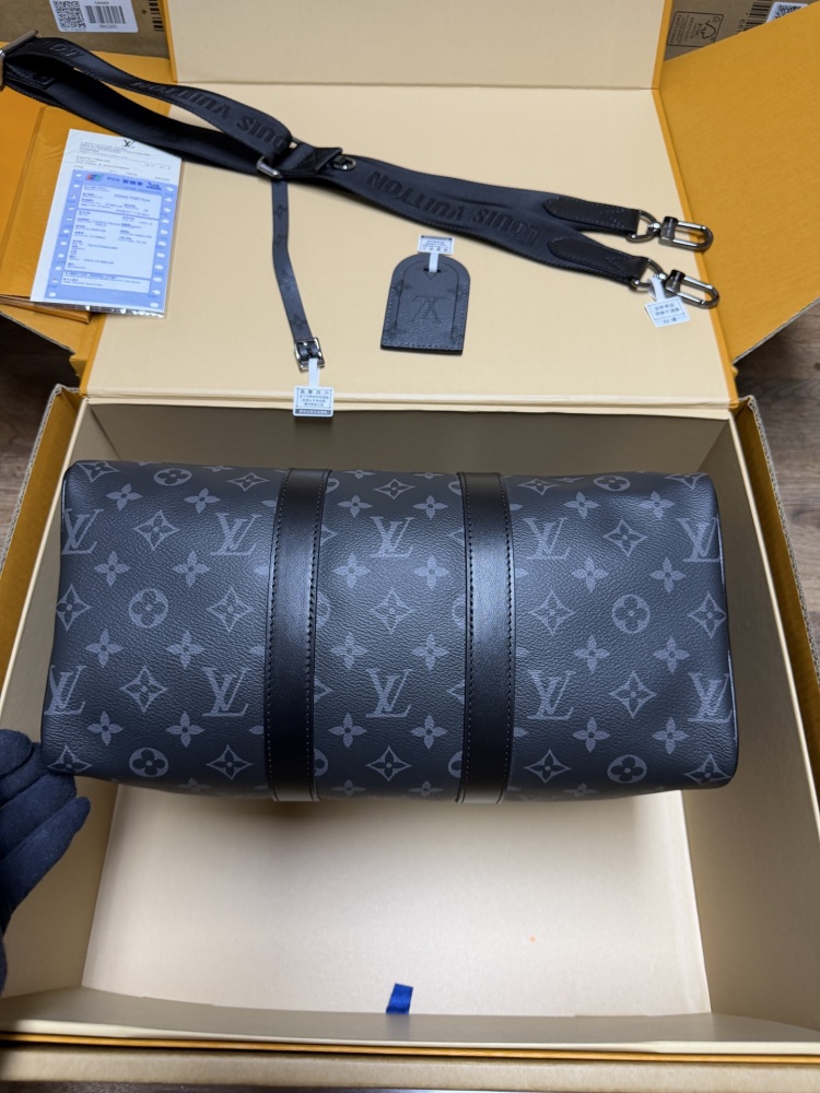 The Louis Vuitton Keepall Bandoulière 35 bag features the classic Monogram Eclipse black and grey canvas.