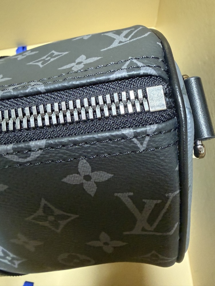 The Louis Vuitton Keepall Bandoulière 35 bag features the classic Monogram Eclipse black and grey canvas.