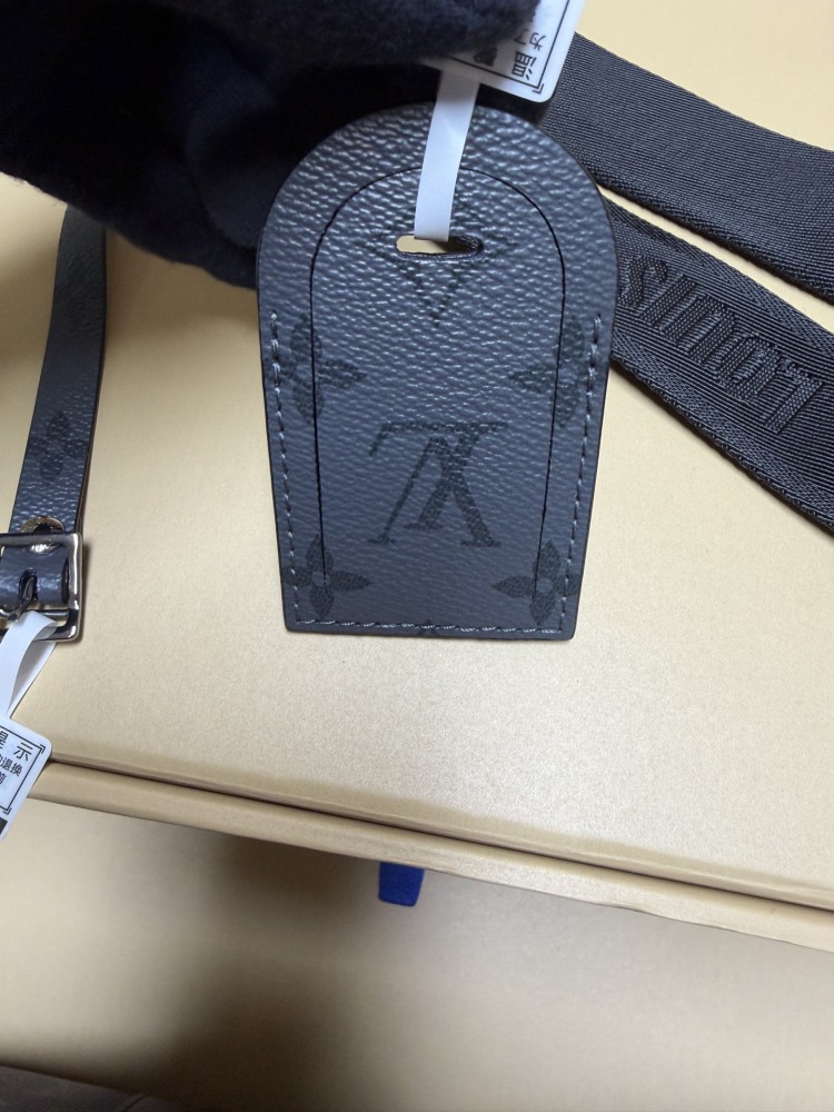 The Louis Vuitton Keepall Bandoulière 35 bag features the classic Monogram Eclipse black and grey canvas.