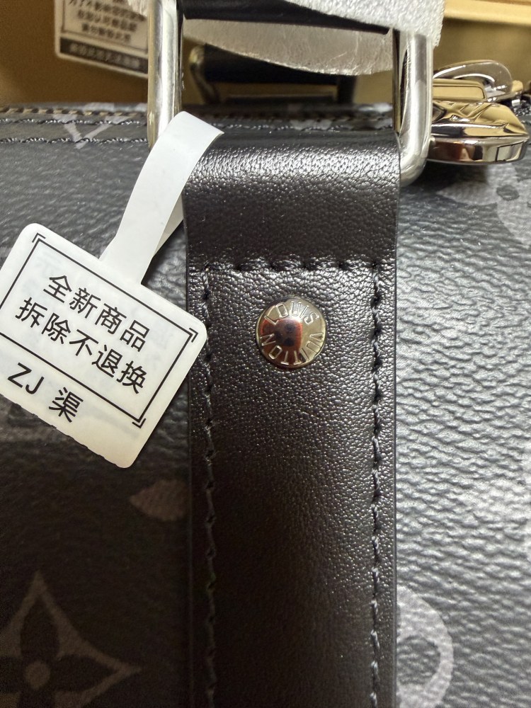 The Louis Vuitton Keepall Bandoulière 35 bag features the classic Monogram Eclipse black and grey canvas.