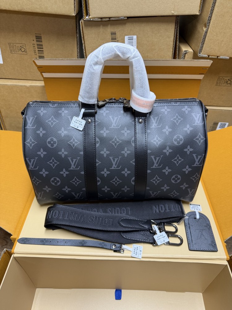 The Louis Vuitton Keepall Bandoulière 35 bag features the classic Monogram Eclipse black and grey canvas.