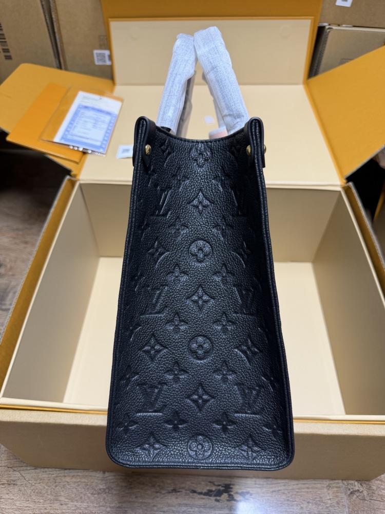 The Louis Vuitton Onthego MM tote bag, featuring an all-black version crafted from embossed Monogram Empreinte cowhide.