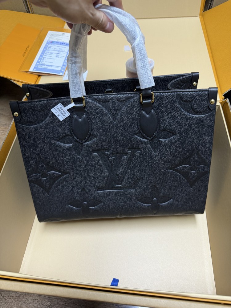 The Louis Vuitton Onthego MM tote bag, featuring an all-black version crafted from embossed Monogram Empreinte cowhide.