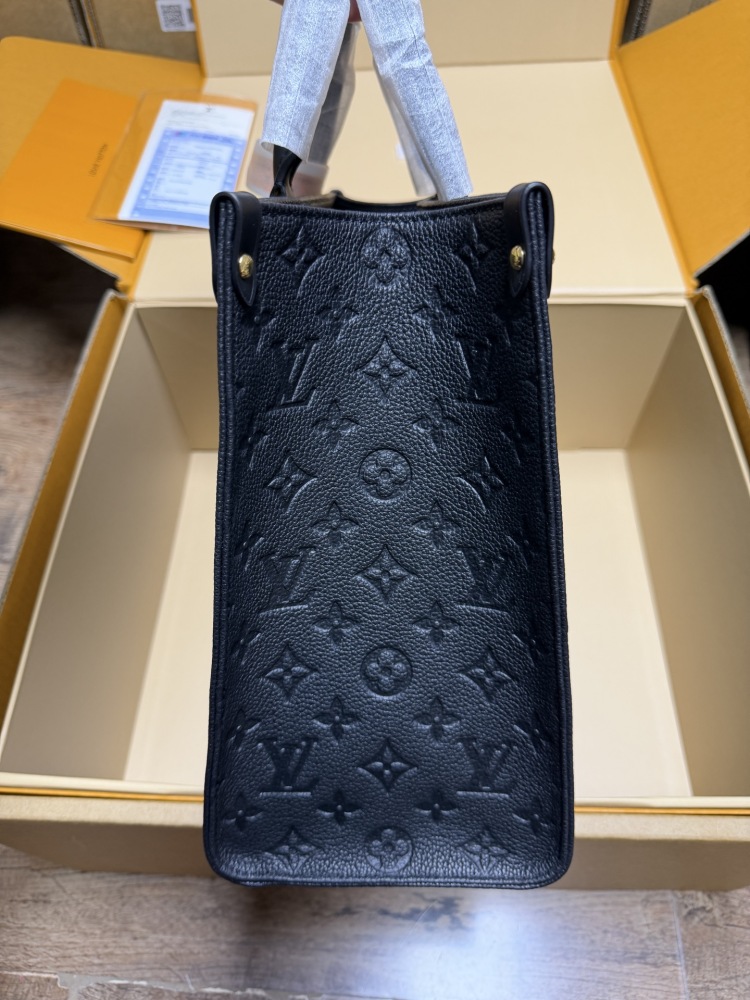 The Louis Vuitton Onthego MM tote bag, featuring an all-black version crafted from embossed Monogram Empreinte cowhide.