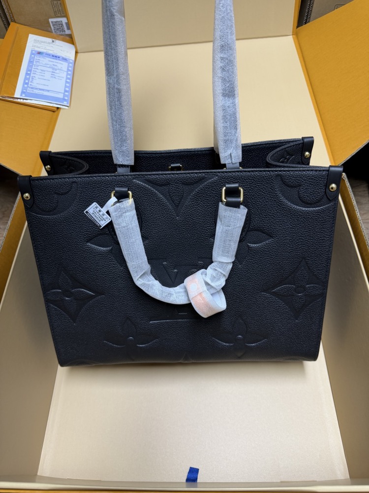 The Louis Vuitton Onthego MM tote bag, featuring an all-black version crafted from embossed Monogram Empreinte cowhide.