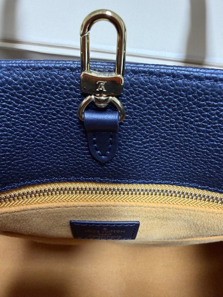 The Louis Vuitton Onthego MM tote bag, featuring an all-black version crafted from embossed Monogram Empreinte cowhide.