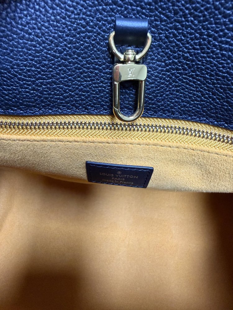 The Louis Vuitton Onthego MM tote bag, featuring an all-black version crafted from embossed Monogram Empreinte cowhide.