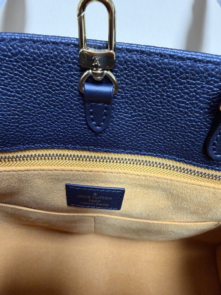 The Louis Vuitton Onthego MM tote bag, featuring an all-black version crafted from embossed Monogram Empreinte cowhide.