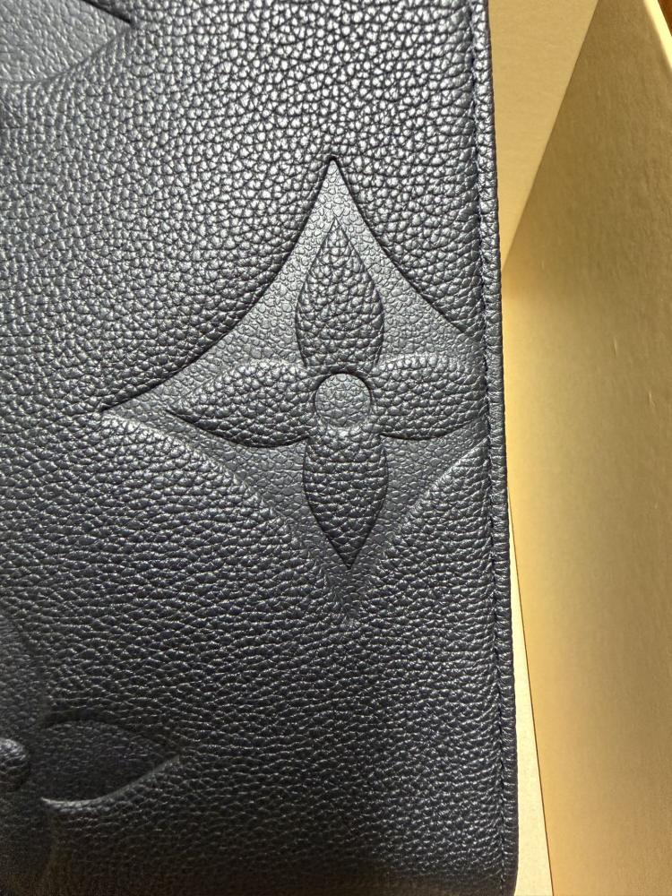 The Louis Vuitton Onthego MM tote bag, featuring an all-black version crafted from embossed Monogram Empreinte cowhide.