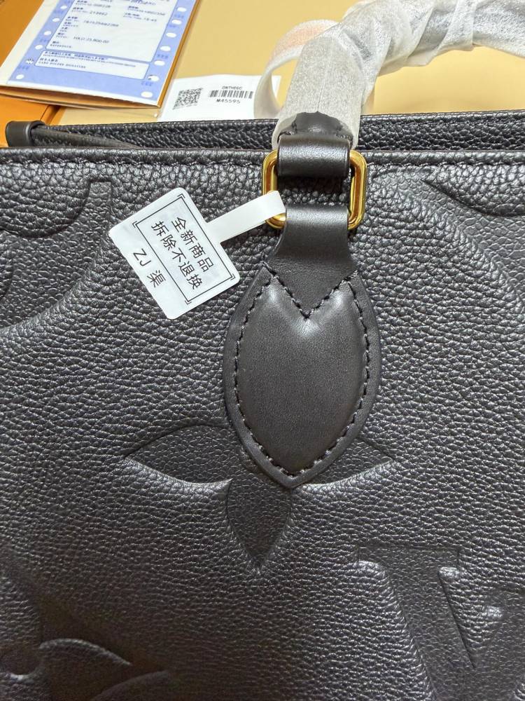 The Louis Vuitton Onthego MM tote bag, featuring an all-black version crafted from embossed Monogram Empreinte cowhide.