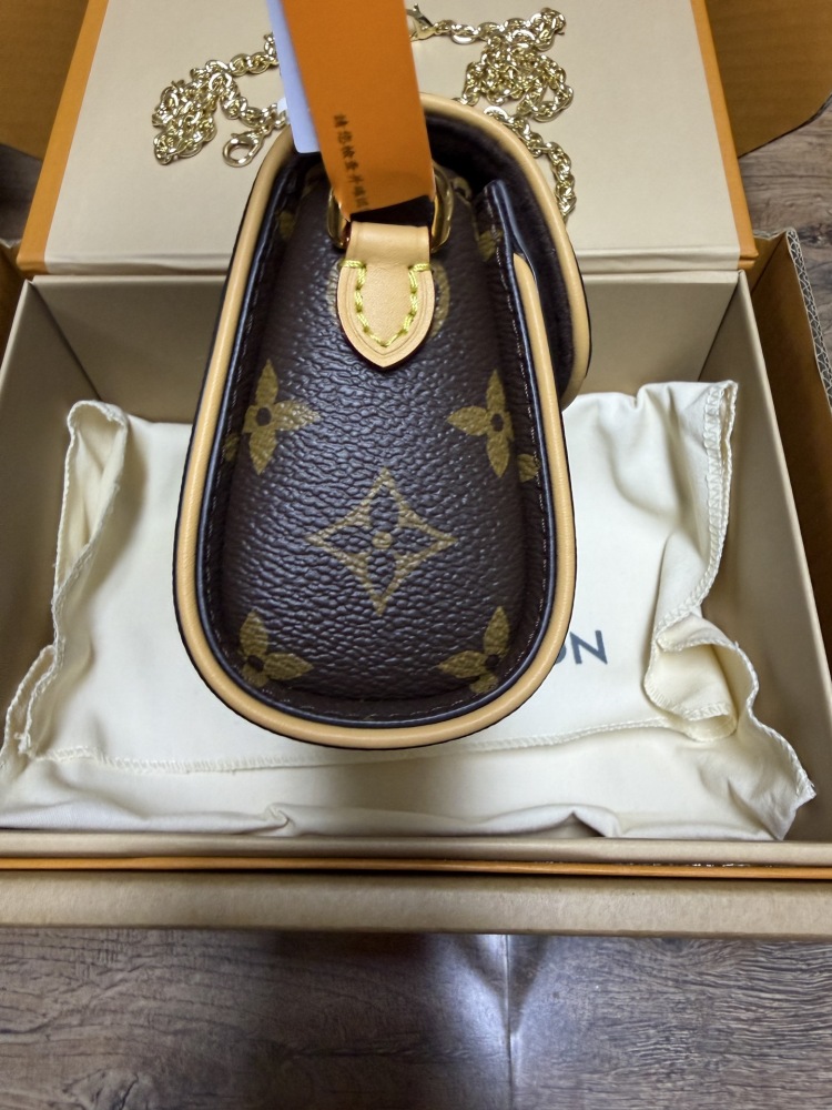 The Louis Vuitton LV East-West Mini Chain Bag (colloquially known as the "Mini Papillon") is crafted from the classic Monogram canvas.