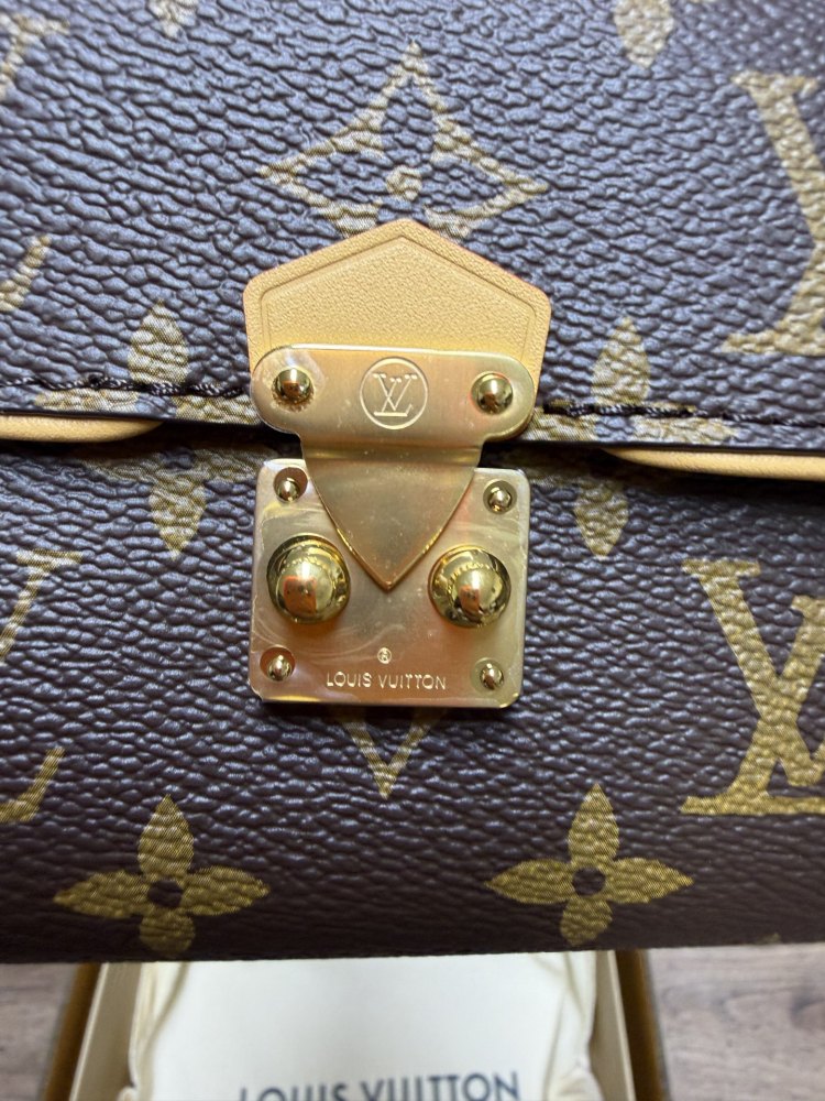 The Louis Vuitton LV East-West Mini Chain Bag (colloquially known as the "Mini Papillon") is crafted from the classic Monogram canvas.