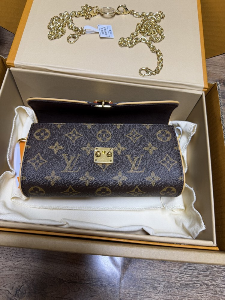 The Louis Vuitton LV East-West Mini Chain Bag (colloquially known as the "Mini Papillon") is crafted from the classic Monogram canvas.