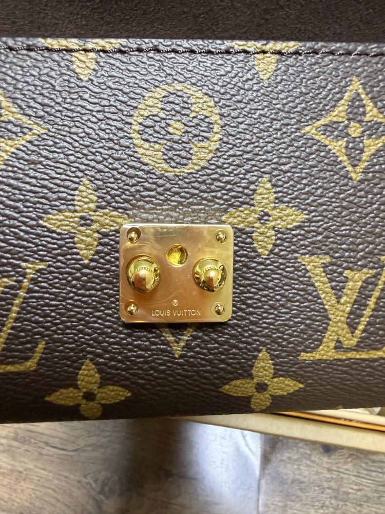 The Louis Vuitton LV East-West Mini Chain Bag (colloquially known as the "Mini Papillon") is crafted from the classic Monogram canvas.