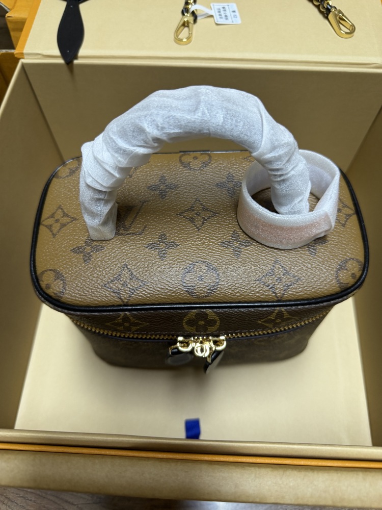 The Louis Vuitton Vanity Small Handbag (Cosmetic Case Style) features the classic Monogram canvas paired with gold-tone hardware.