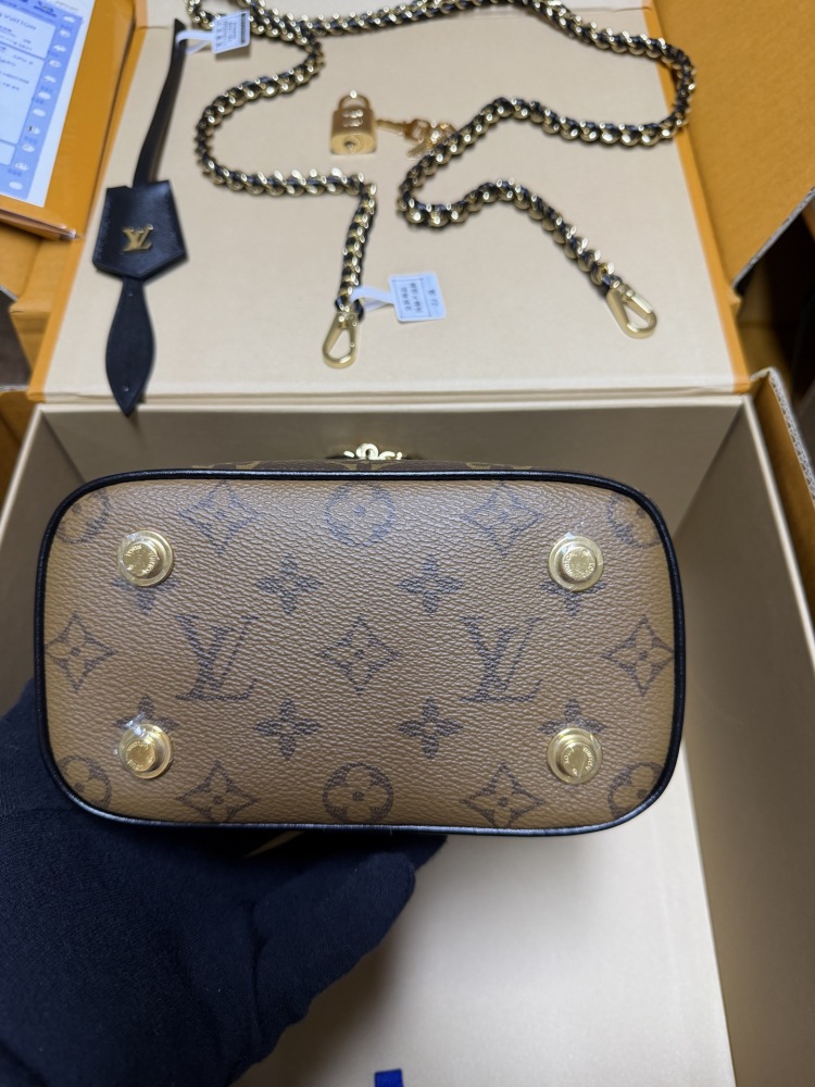 The Louis Vuitton Vanity Small Handbag (Cosmetic Case Style) features the classic Monogram canvas paired with gold-tone hardware.