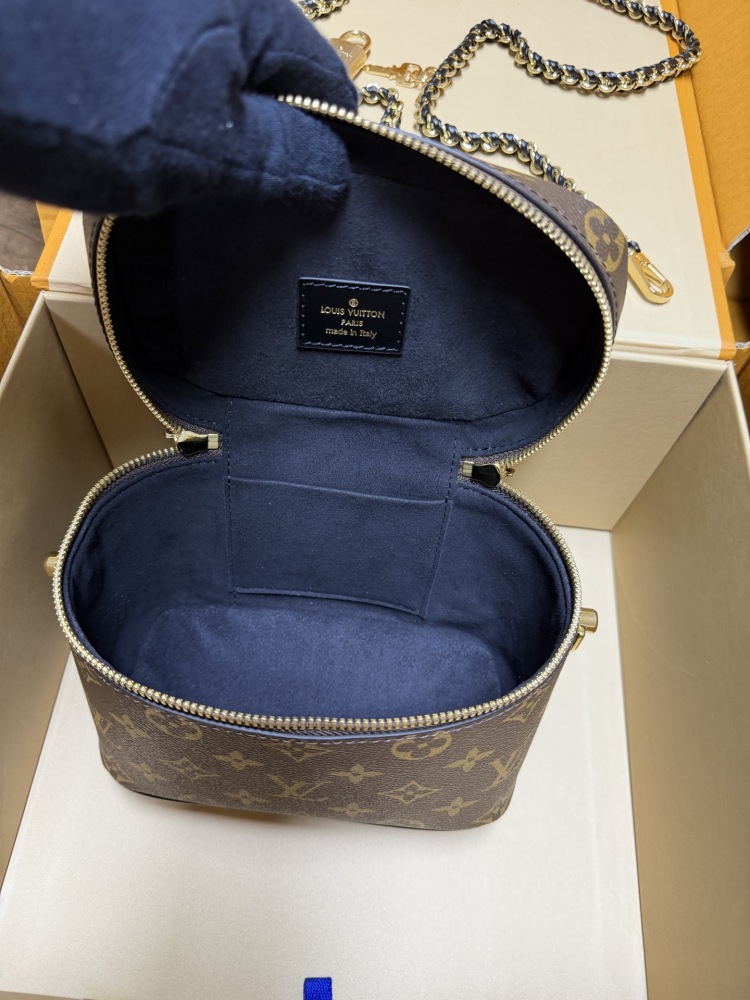 The Louis Vuitton Vanity Small Handbag (Cosmetic Case Style) features the classic Monogram canvas paired with gold-tone hardware.