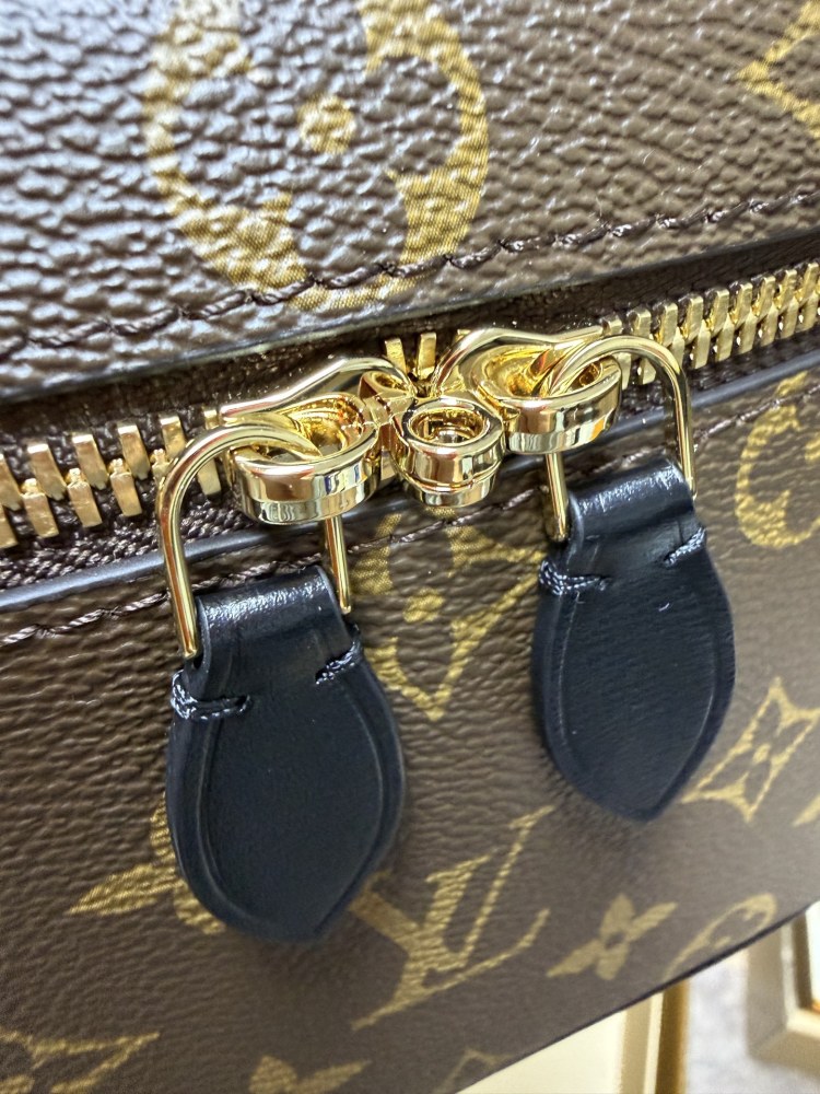The Louis Vuitton Vanity Small Handbag (Cosmetic Case Style) features the classic Monogram canvas paired with gold-tone hardware.