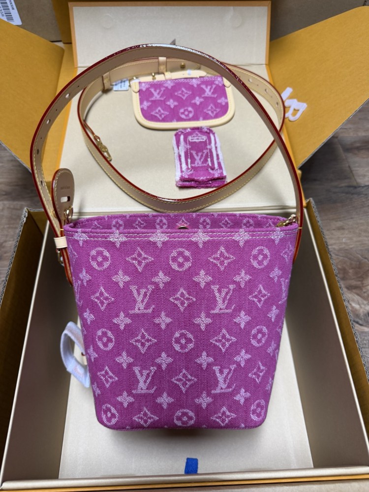The Louis Vuitton Vanity Small Handbag (Vanity Case style) is crafted from the brand's classic Monogram-printed pink denim canvas, accented with natural cowhide trim and gold-tone hardware.