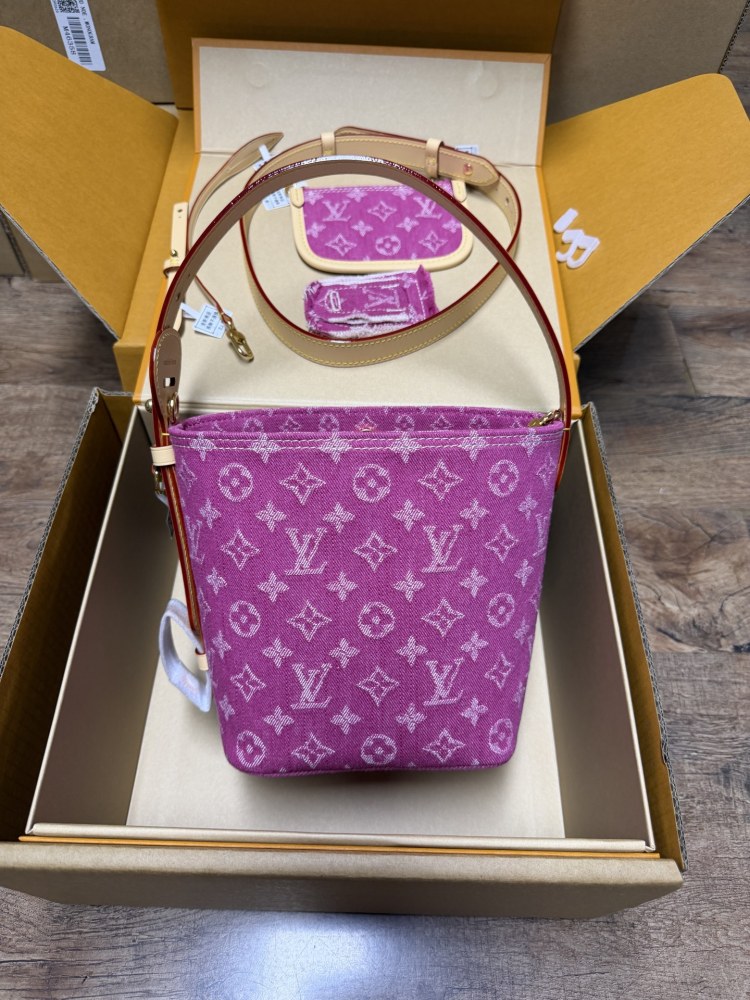 The Louis Vuitton Vanity Small Handbag (Vanity Case style) is crafted from the brand's classic Monogram-printed pink denim canvas, accented with natural cowhide trim and gold-tone hardware.
