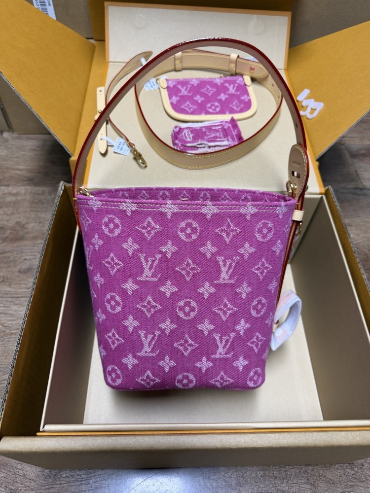 The Louis Vuitton Vanity Small Handbag (Vanity Case style) is crafted from the brand's classic Monogram-printed pink denim canvas, accented with natural cowhide trim and gold-tone hardware.