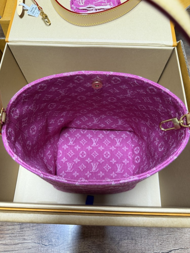 The Louis Vuitton Vanity Small Handbag (Vanity Case style) is crafted from the brand's classic Monogram-printed pink denim canvas, accented with natural cowhide trim and gold-tone hardware.