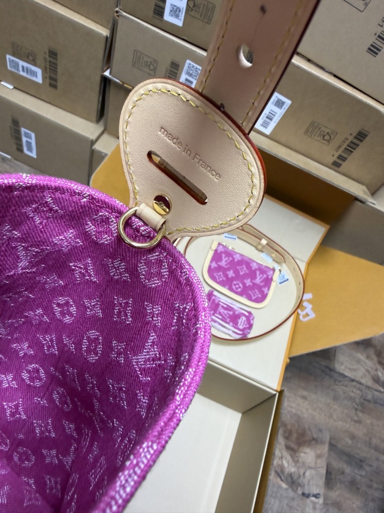 The Louis Vuitton Vanity Small Handbag (Vanity Case style) is crafted from the brand's classic Monogram-printed pink denim canvas, accented with natural cowhide trim and gold-tone hardware.