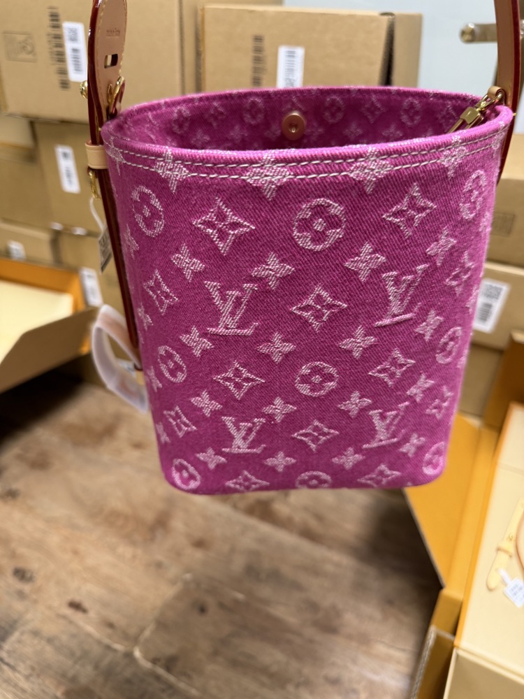 The Louis Vuitton Vanity Small Handbag (Vanity Case style) is crafted from the brand's classic Monogram-printed pink denim canvas, accented with natural cowhide trim and gold-tone hardware.