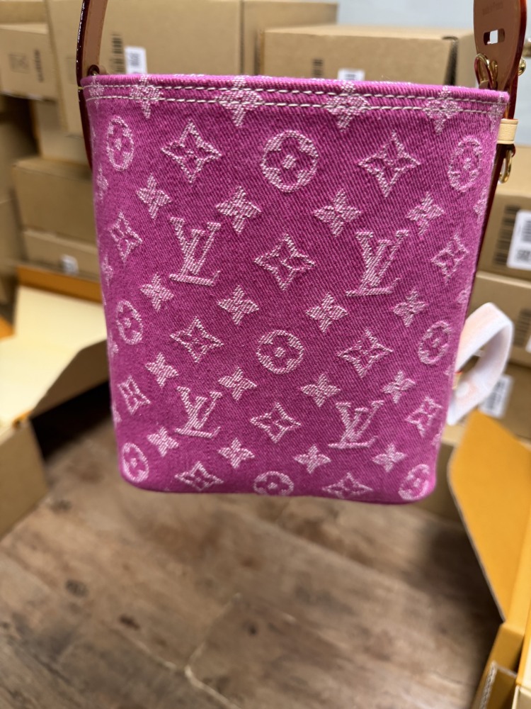 The Louis Vuitton Vanity Small Handbag (Vanity Case style) is crafted from the brand's classic Monogram-printed pink denim canvas, accented with natural cowhide trim and gold-tone hardware.
